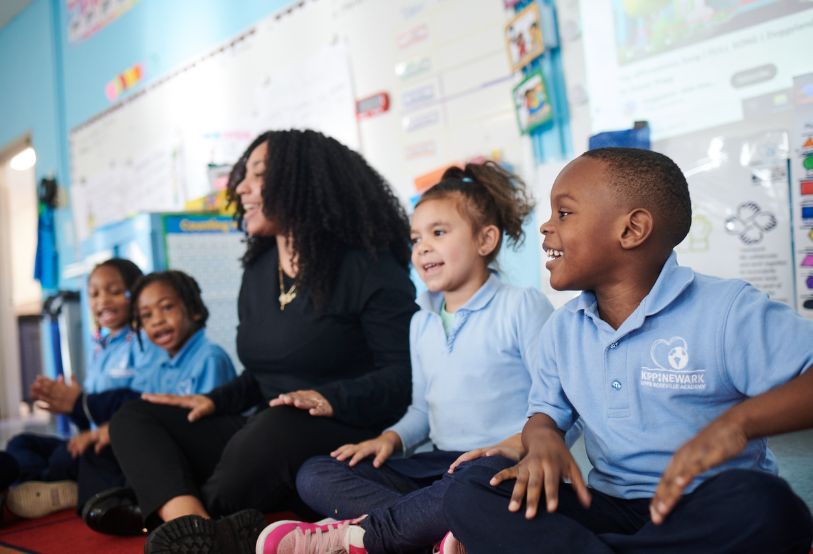 teacher and students in classroom sitting down