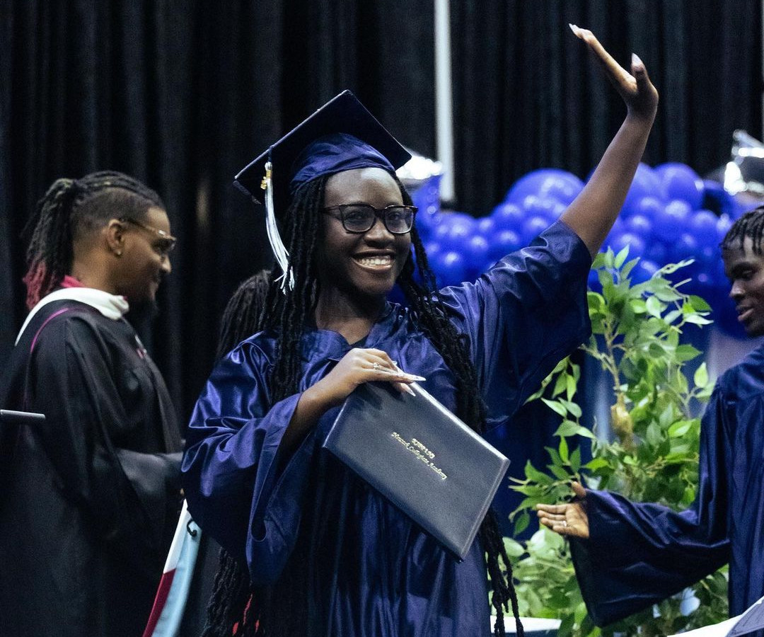 student walking across stage at graduation